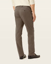 Side view of model wearing Dark Pebble Easy Khakis, Straight Fit.