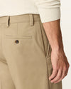 Side view of model wearing Khaki Easy Stretch Khakis, Relaxed Fit.