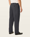 Back view of model wearing Black Easy Stretch Khakis, Pleated, Relaxed Fit.