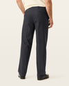 Side view of model wearing Beautiful Black Signature Iron Free Khakis, Relaxed Fit with Stain Defender®.