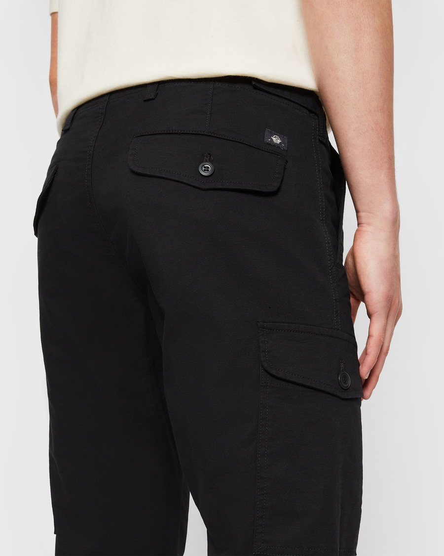 View of model wearing Beautiful Black Cargo Pants, Slim Tapered Fit.