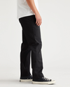 Side view of model wearing Beautiful Black Essential Chinos, Slim Fit.