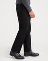 Side view of model wearing Beautiful Black Signature Iron Free Khakis, Pleated, Classic Fit with Stain Defender®.