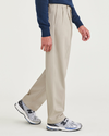 Side view of model wearing Cloud Signature Iron Free Khakis, Pleated, Relaxed Fit with Stain Defender®.
