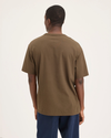 Back view of model wearing Coffee Liquor Eighty-Six Tee, Relaxed Fit.