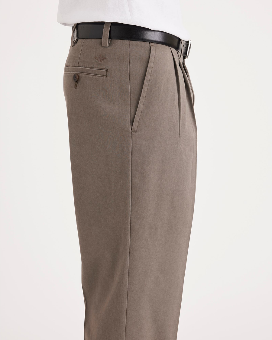 Side view of model wearing Dark Pebble Easy Khakis, Pleated, Classic Fit.