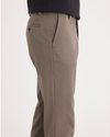 Side view of model wearing Dark Pebble Easy Khakis, Straight Fit.