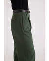 Side view of model wearing Deep Forest Pleated Pants, High Wide Fit.