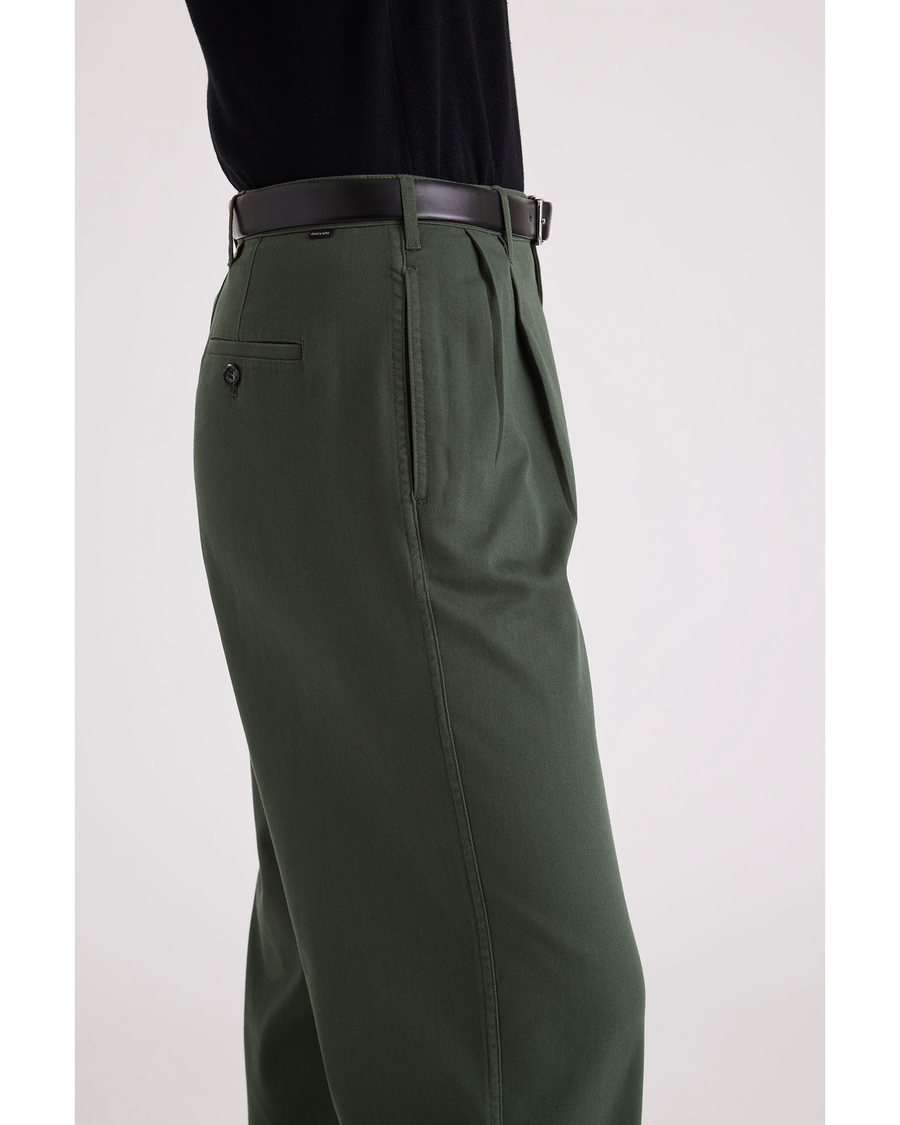 Side view of model wearing Deep Forest Pleated Pants, High Wide Fit.