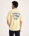 Back view of model wearing Dusty Yellow Logo Tee, Slim Fit.