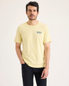Front view of model wearing Dusty Yellow Logo Tee, Slim Fit.