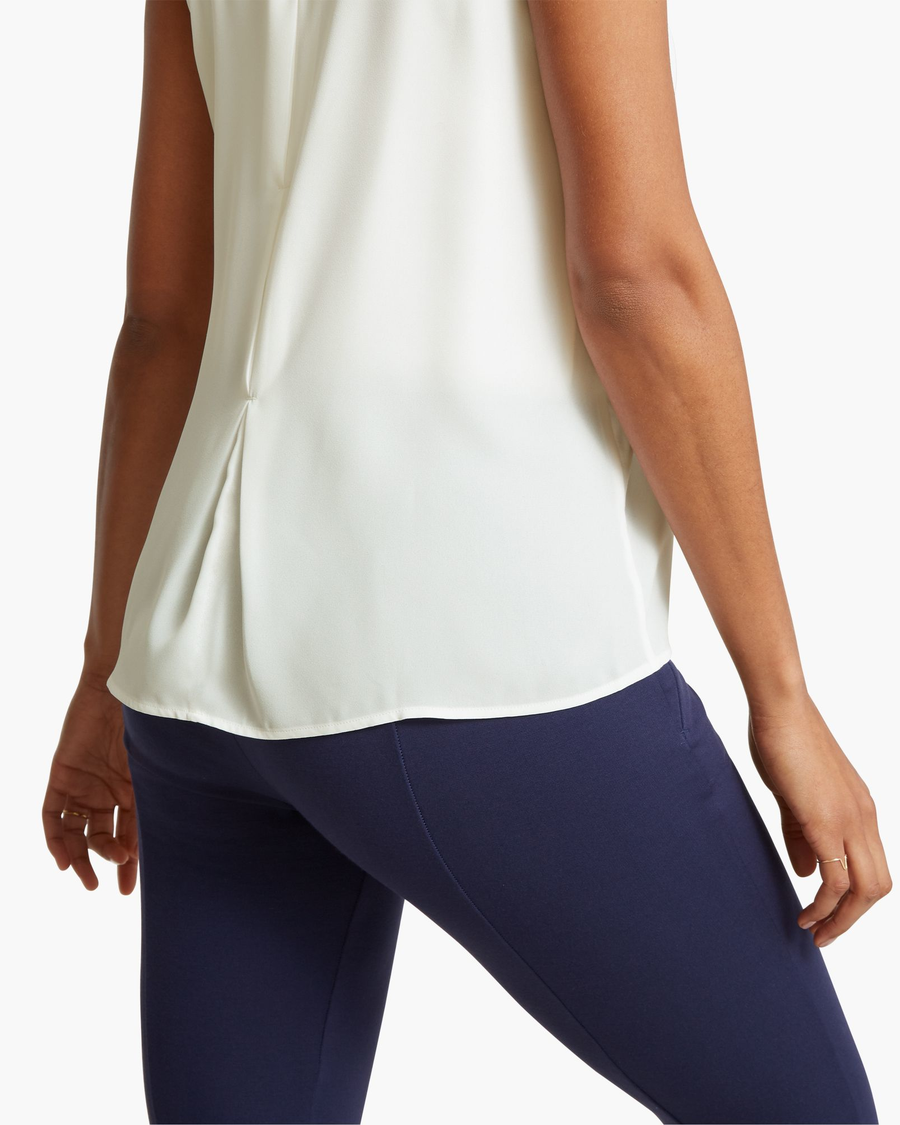 View of model wearing Egret Back Detail Tank Top.