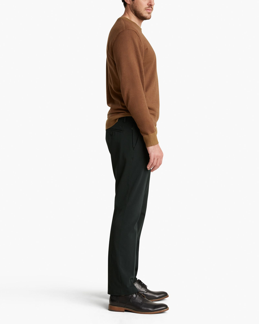 Side view of model wearing Mineral Black City Tech Trousers, Straight Fit.