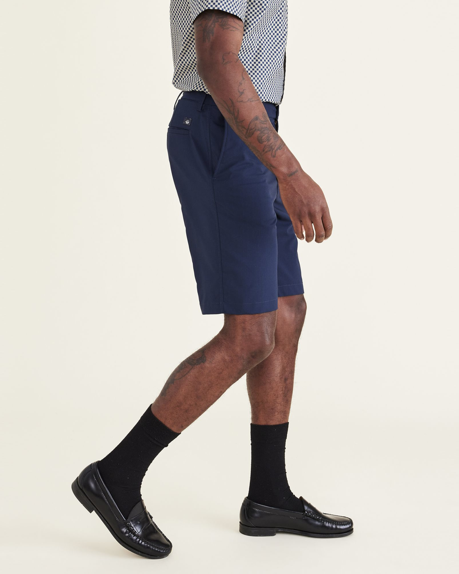 Side view of model wearing Navy Blazer Ultimate Go Shorts, Straight Fit.