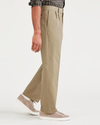 Side view of model wearing New British Khaki Signature Iron Free Khakis, Pleated, Classic Fit with Stain Defender®.