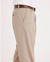 Side view of model wearing Timber Wolf Easy Khakis, Pleated, Classic Fit.